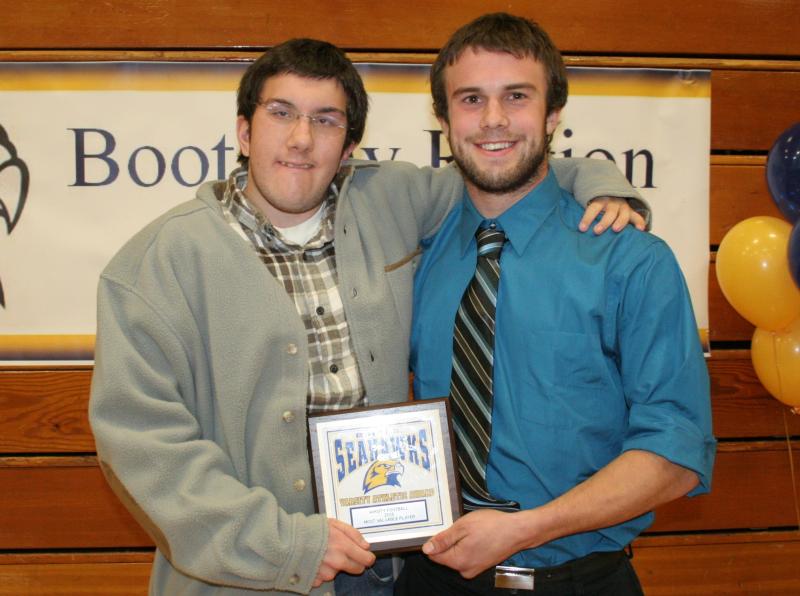 Friends and football teammates. Thomas Cornell, left, gives his friend and football teammate Jason Maddocks a hug after Maddocks gave his most valuable player plaque to Cornell at the BRHS fall sports awards. KEVIN BURNHAM/Boothbay Register